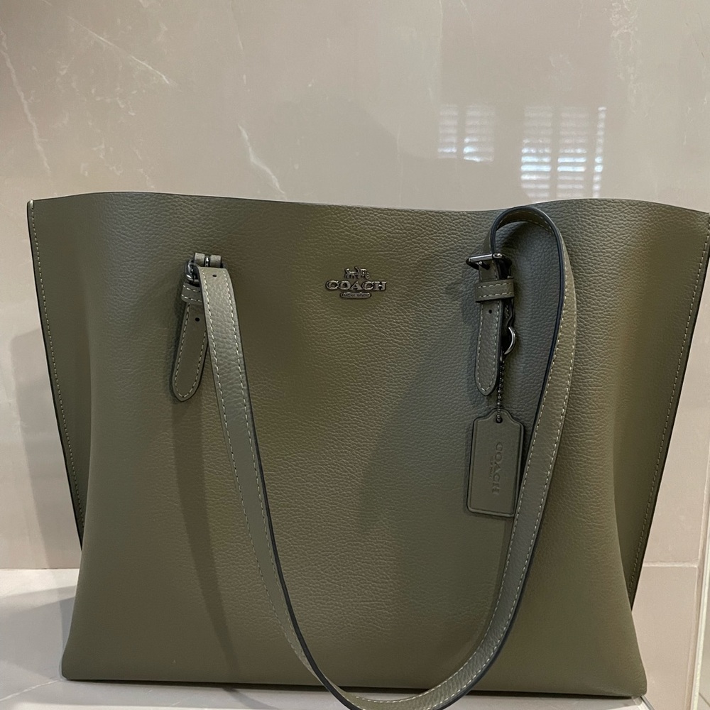 Green coach bag, never used!! Burgundy interior zipper pocket, 11” x 15 x 5”